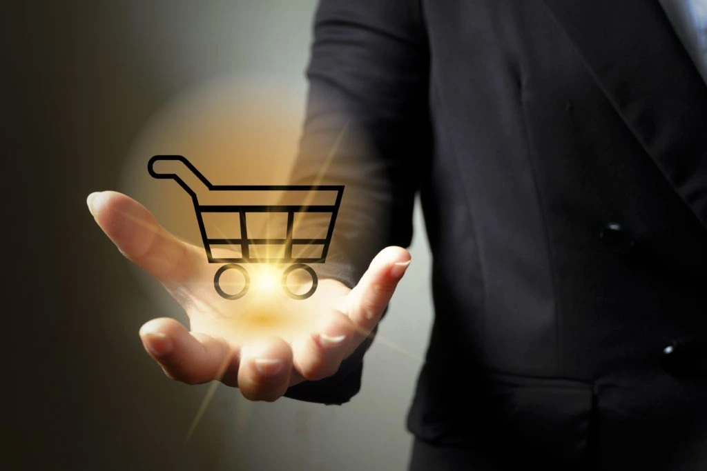 woman holding a shiny e-commerce shopping cart 