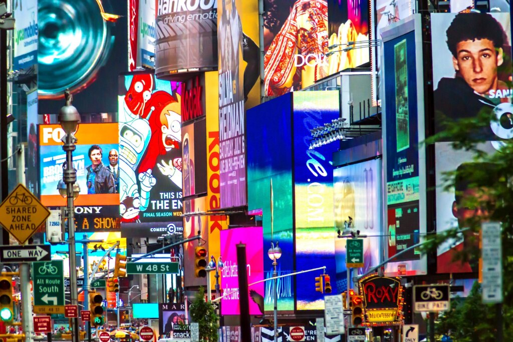 Trying to get a cut of advertising visibility, visualized in a busy street of ads in NYC
