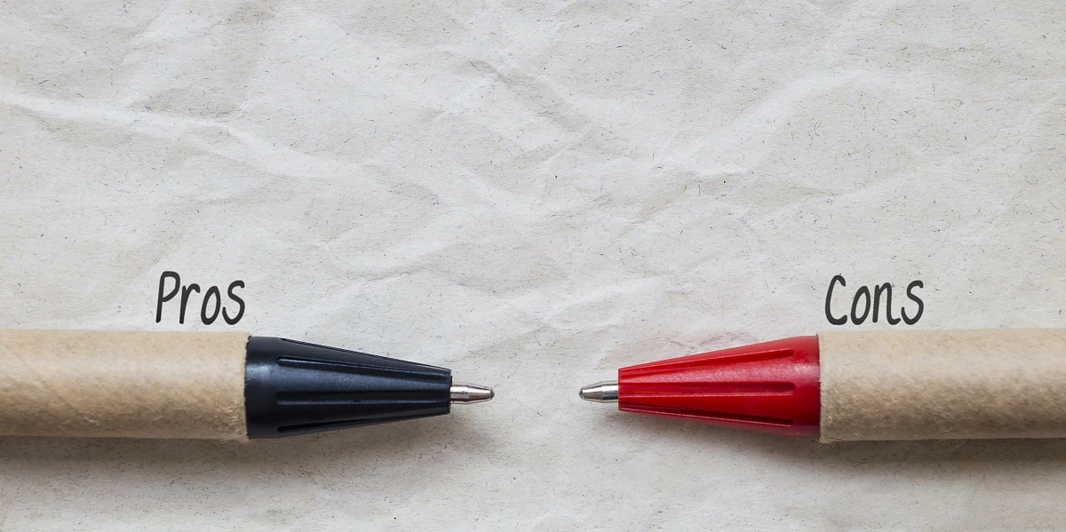 Pros and Cons - two pens facing each other