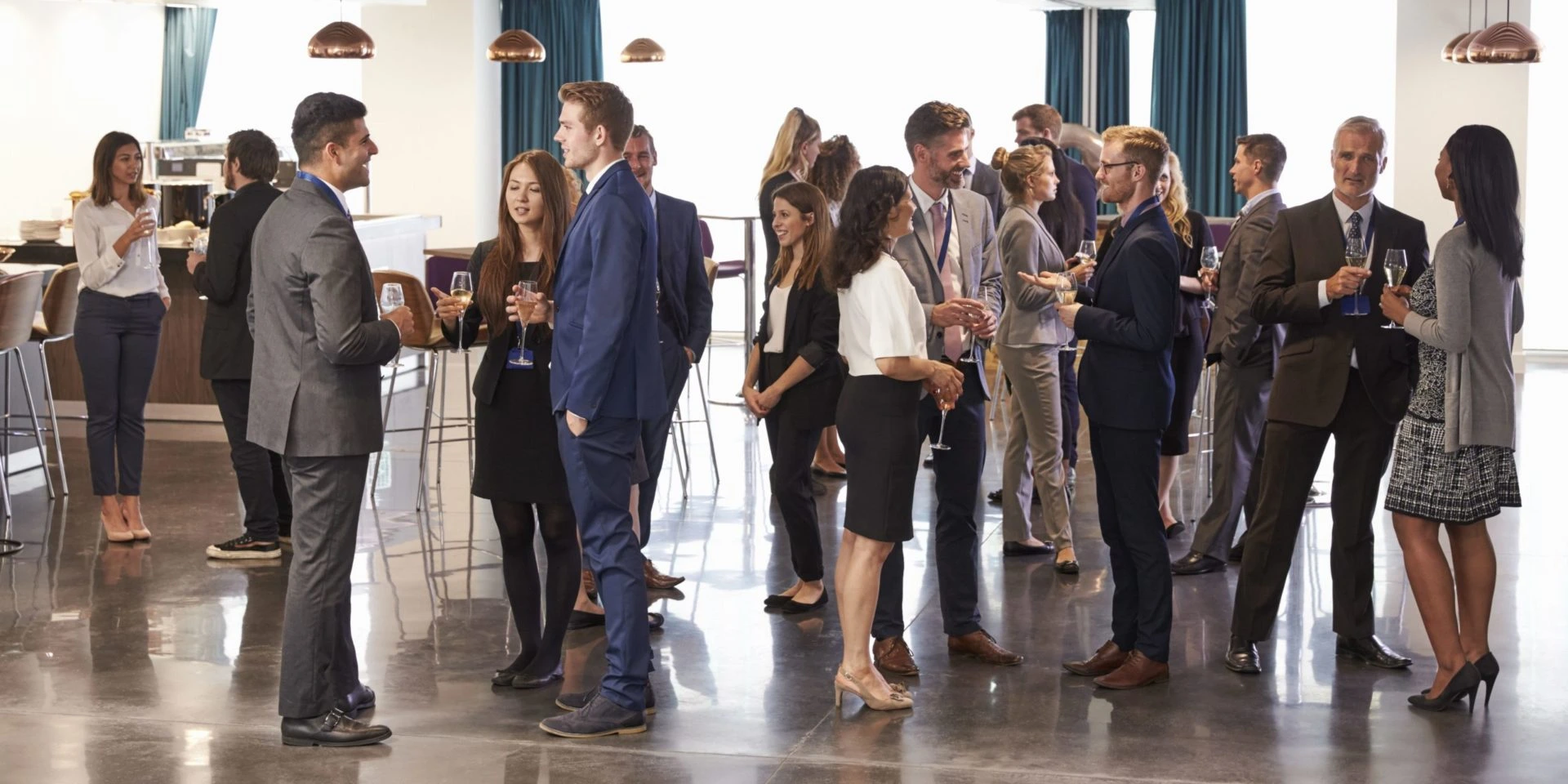 group of business professionals standing and talking in open conference room