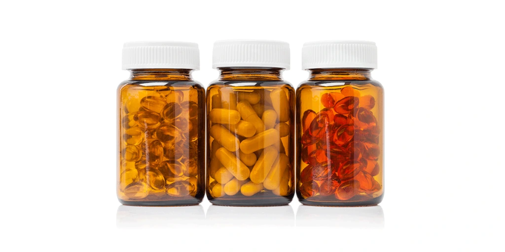 three amber bottles of various pills