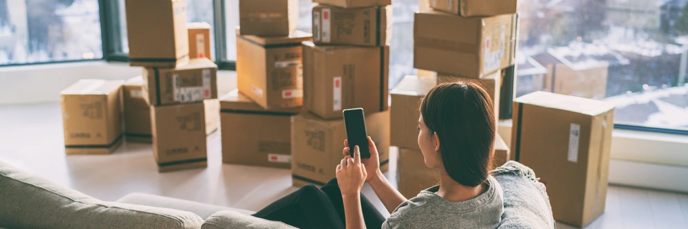 Woman packaging used items to sell on Amazon