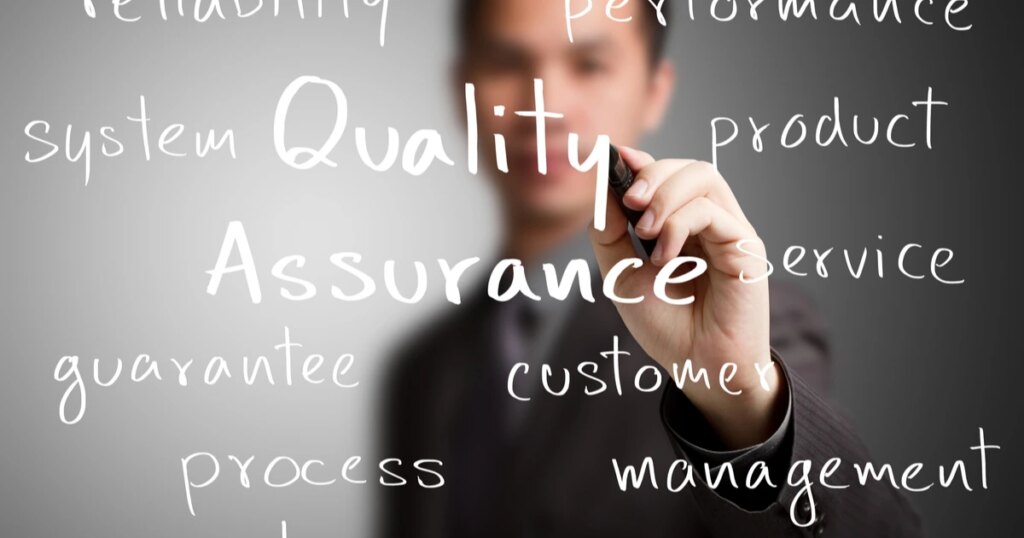 Person writing down all the essential terms associated with quality assurance